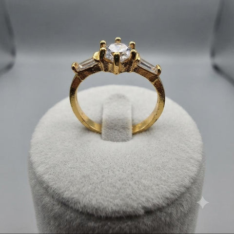 Classic Gold Three-Stone Ring with Round Center and Baguette Accents